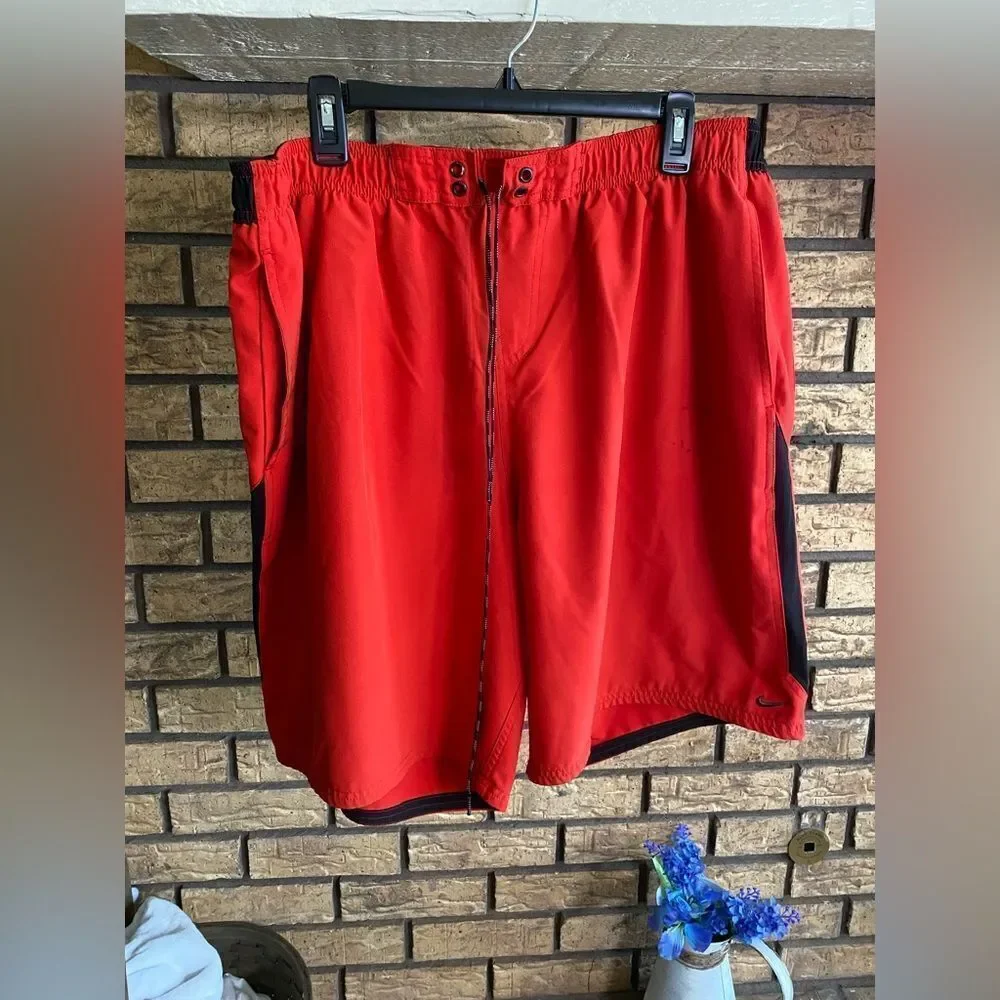 Red and black Nike swim trunks‎